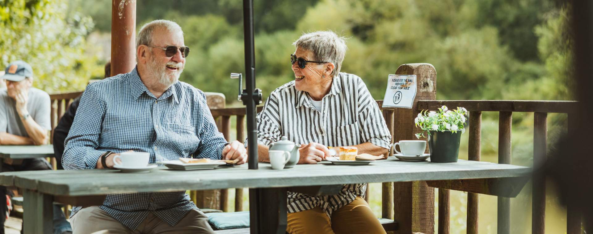 A couple sat in the outdoor seating area at Folly Lake Cafe enjoying coffee and cake.