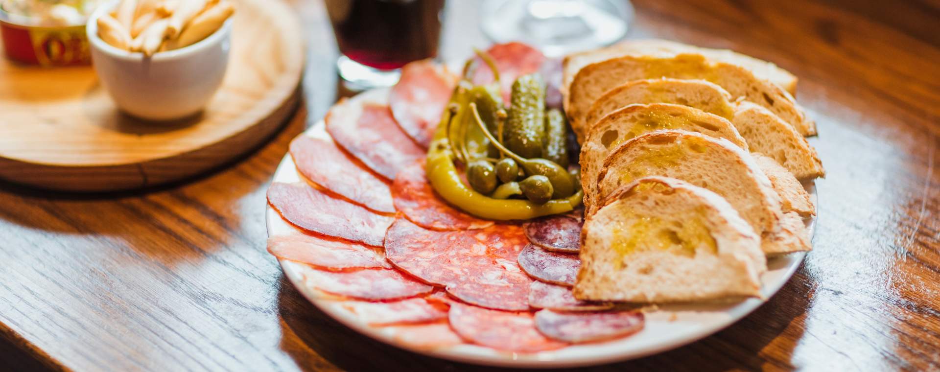 Charcuterie style plate with meat, pickles and bread at the Pig and Whistle.