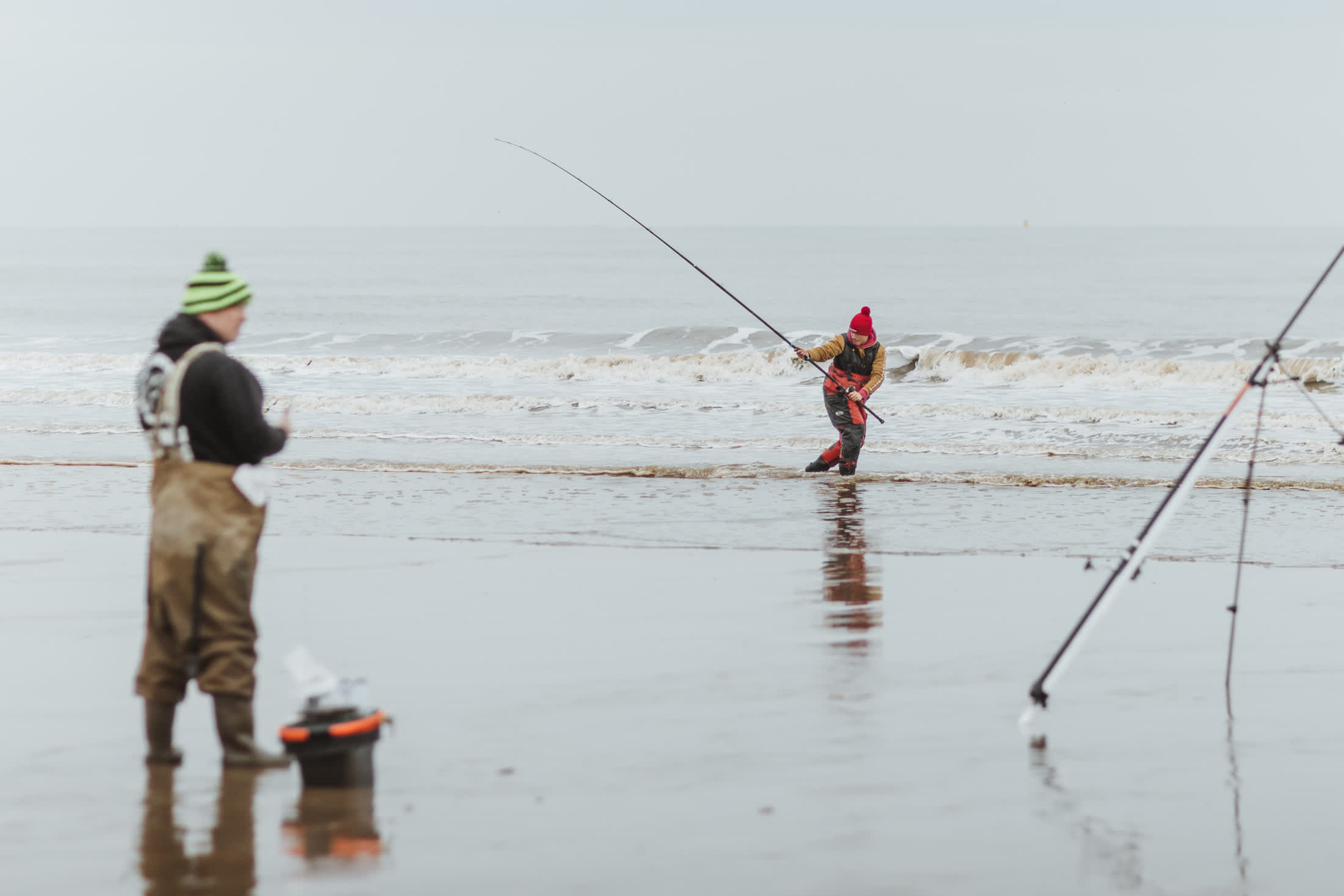 Anglers rebaiting and another in the shores casting the rod