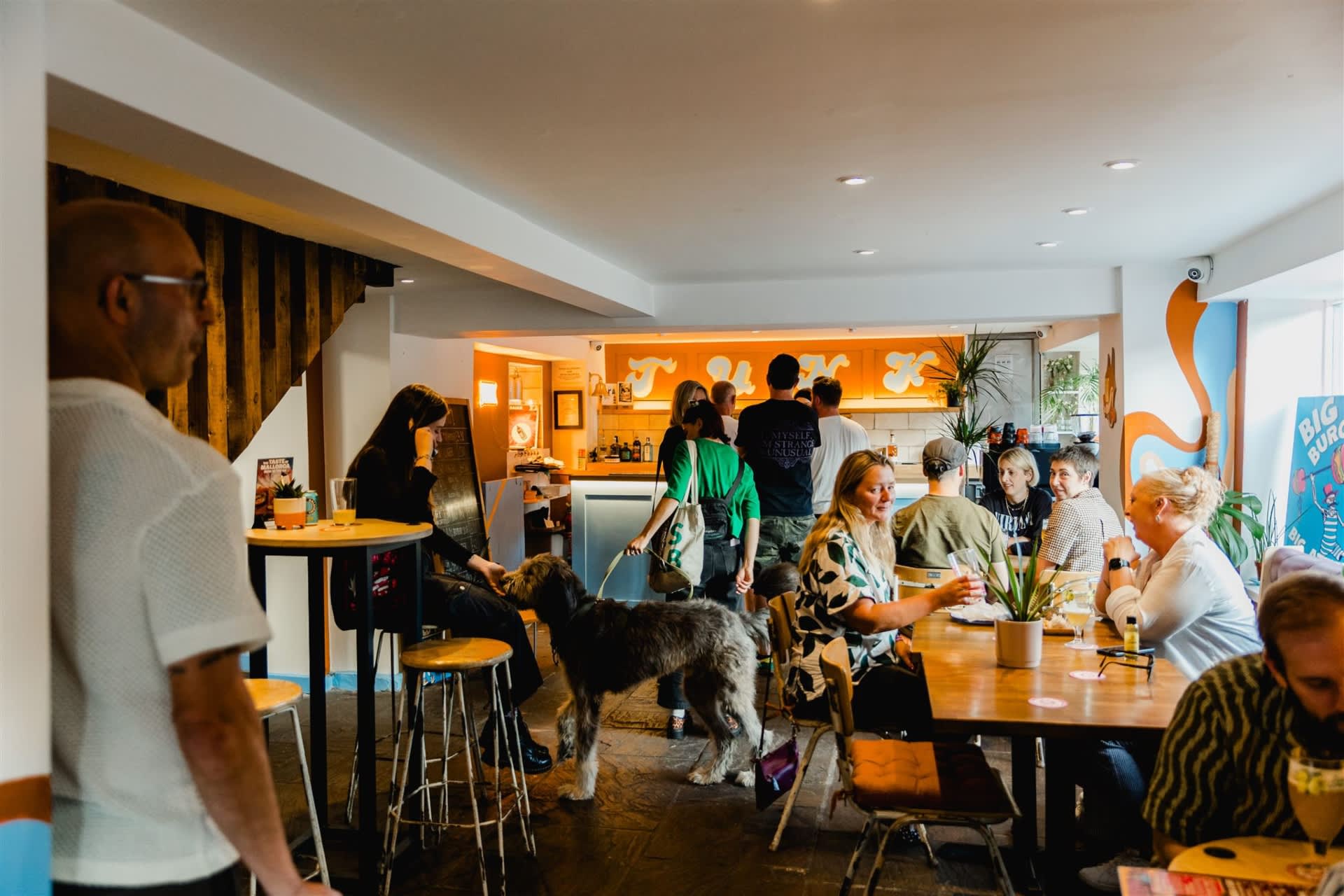 Inside Junk Bar with tables of people enjoying a drink