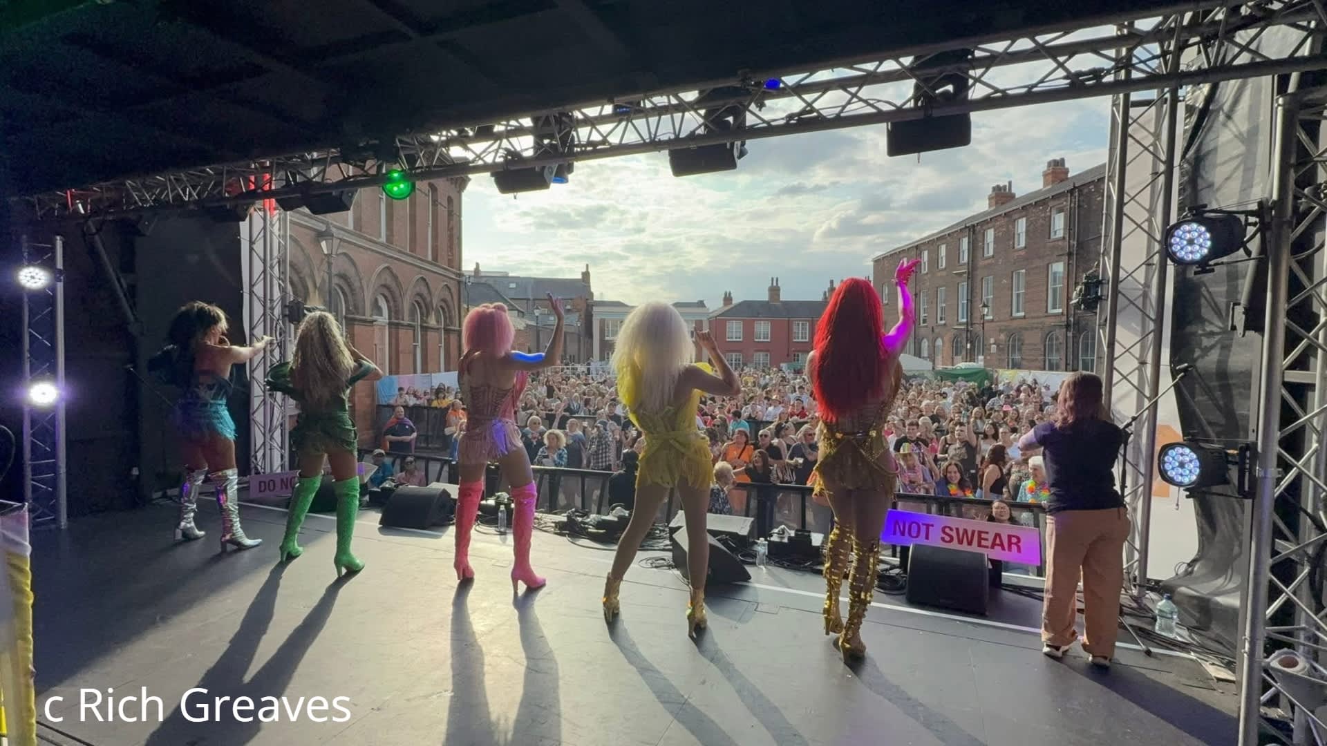 performers looking out over a crowd