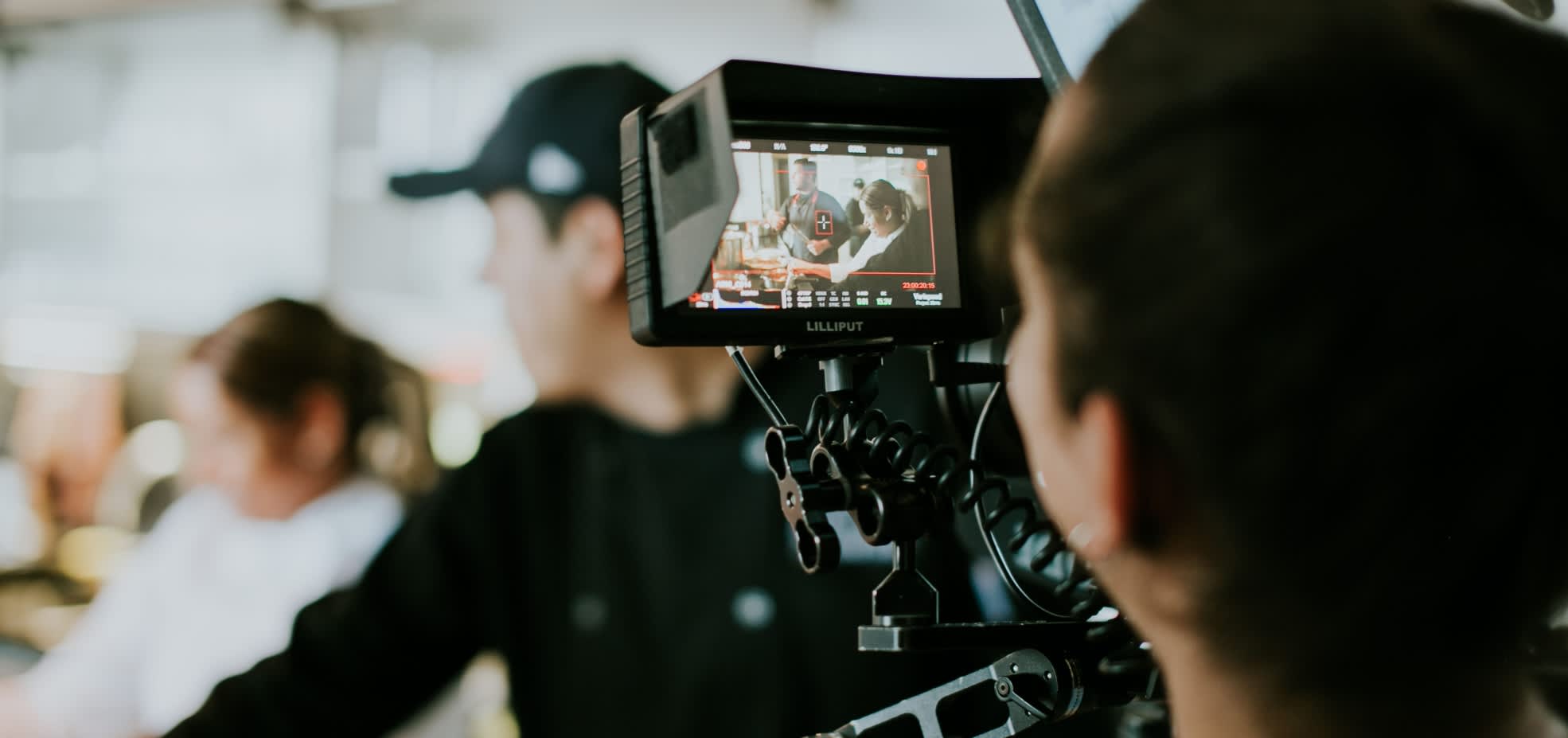 A camera crew films people.