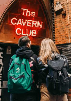 Two people stand outside the Cavern Club