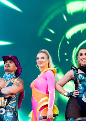 The Vengaboys standing on stage in bright, flourescent outfits