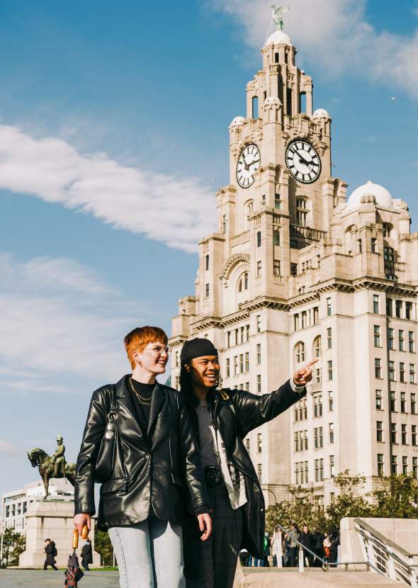 Two people walking on the Pier head in leather jackets