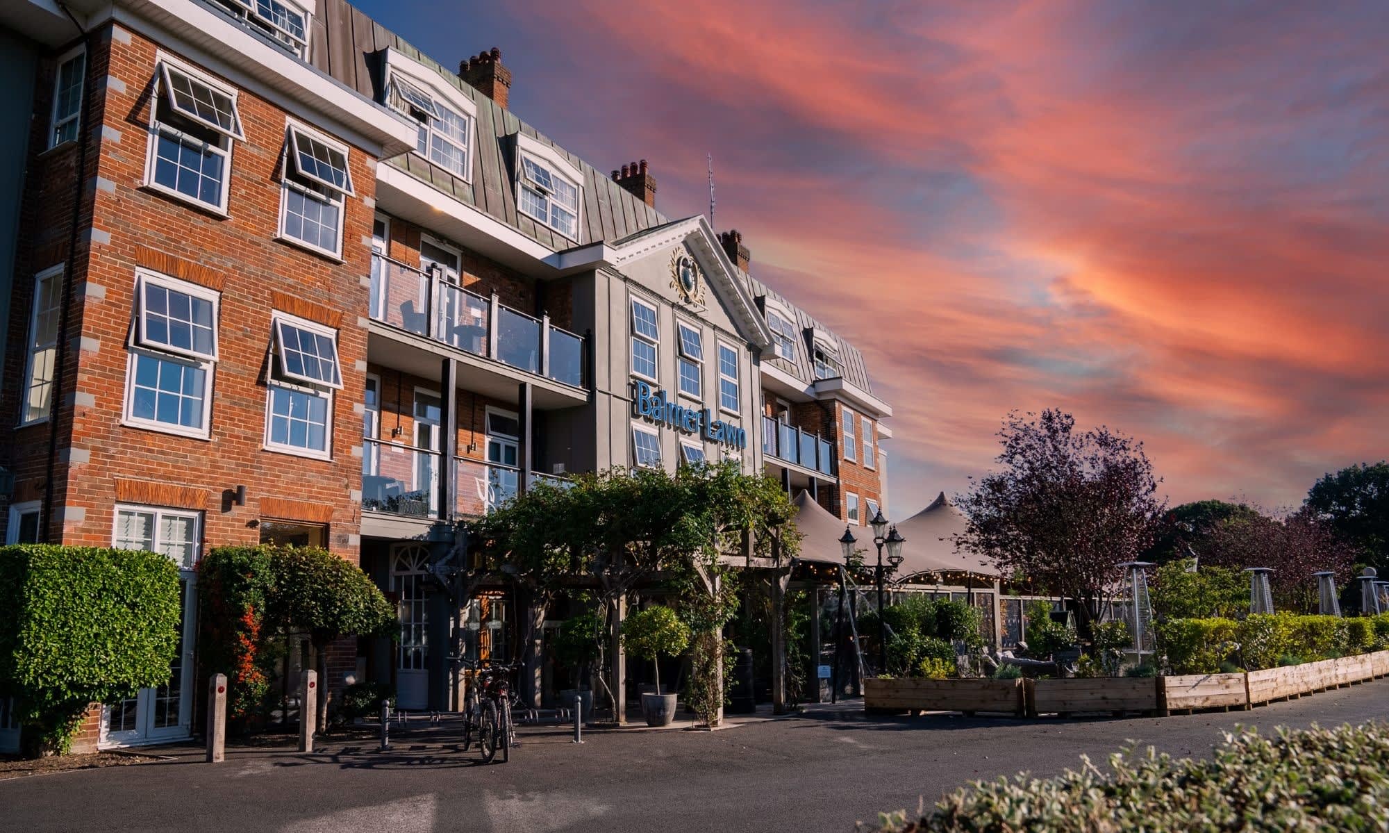Balmer Lawn Hotel from the front with a sunset in the background
