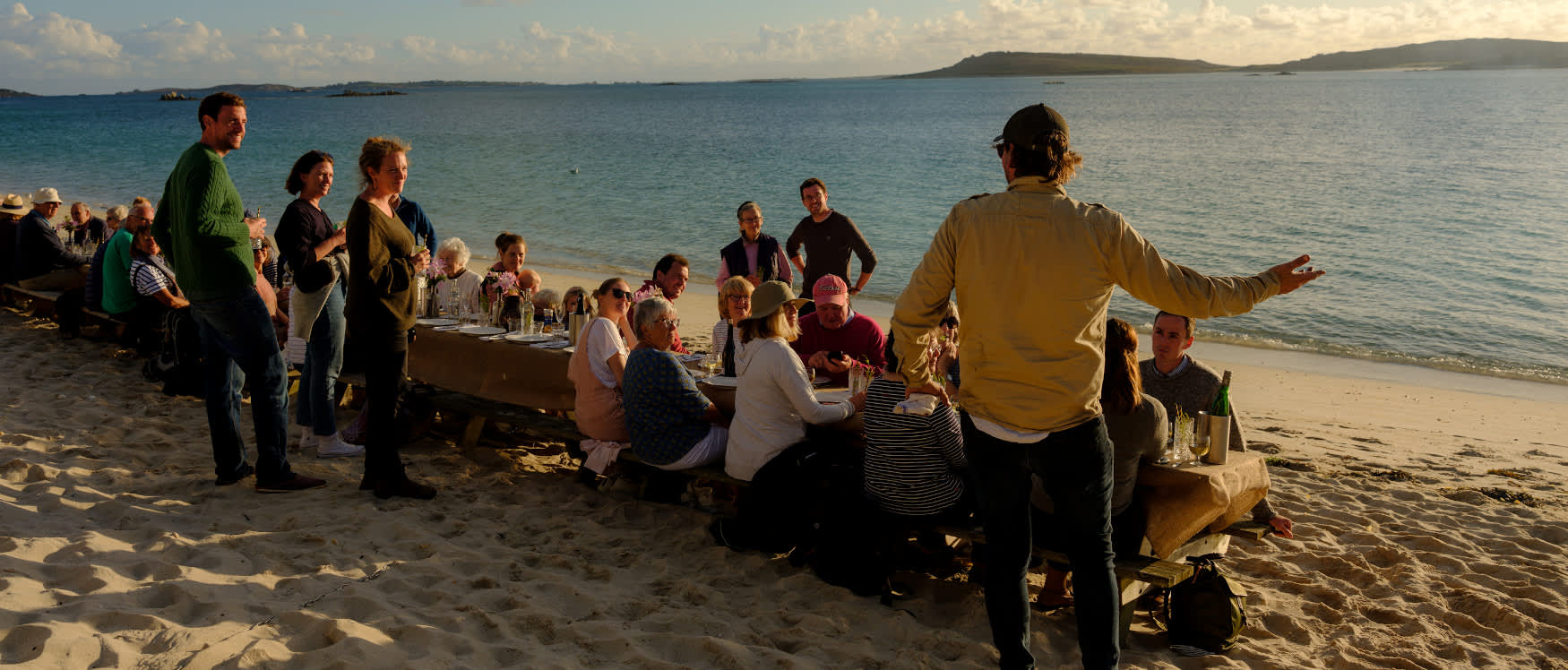 IOS Nav Landscape Large - F&D -  Taste of Scilly - Simon Stallard in front of table Tresco 1750 x748