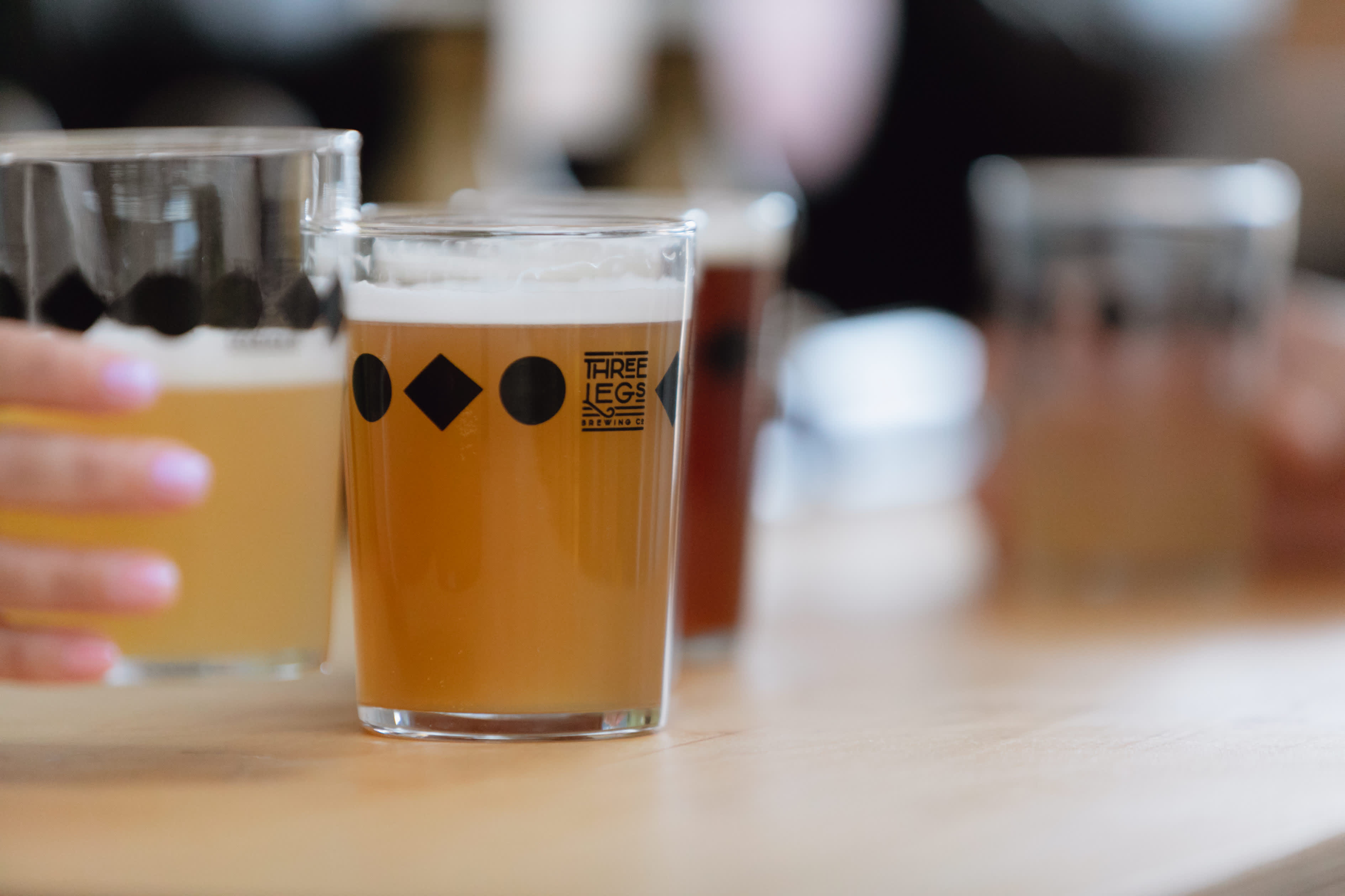 Two pints of craft beer on the bar at Three Legs Brewery, Sussex