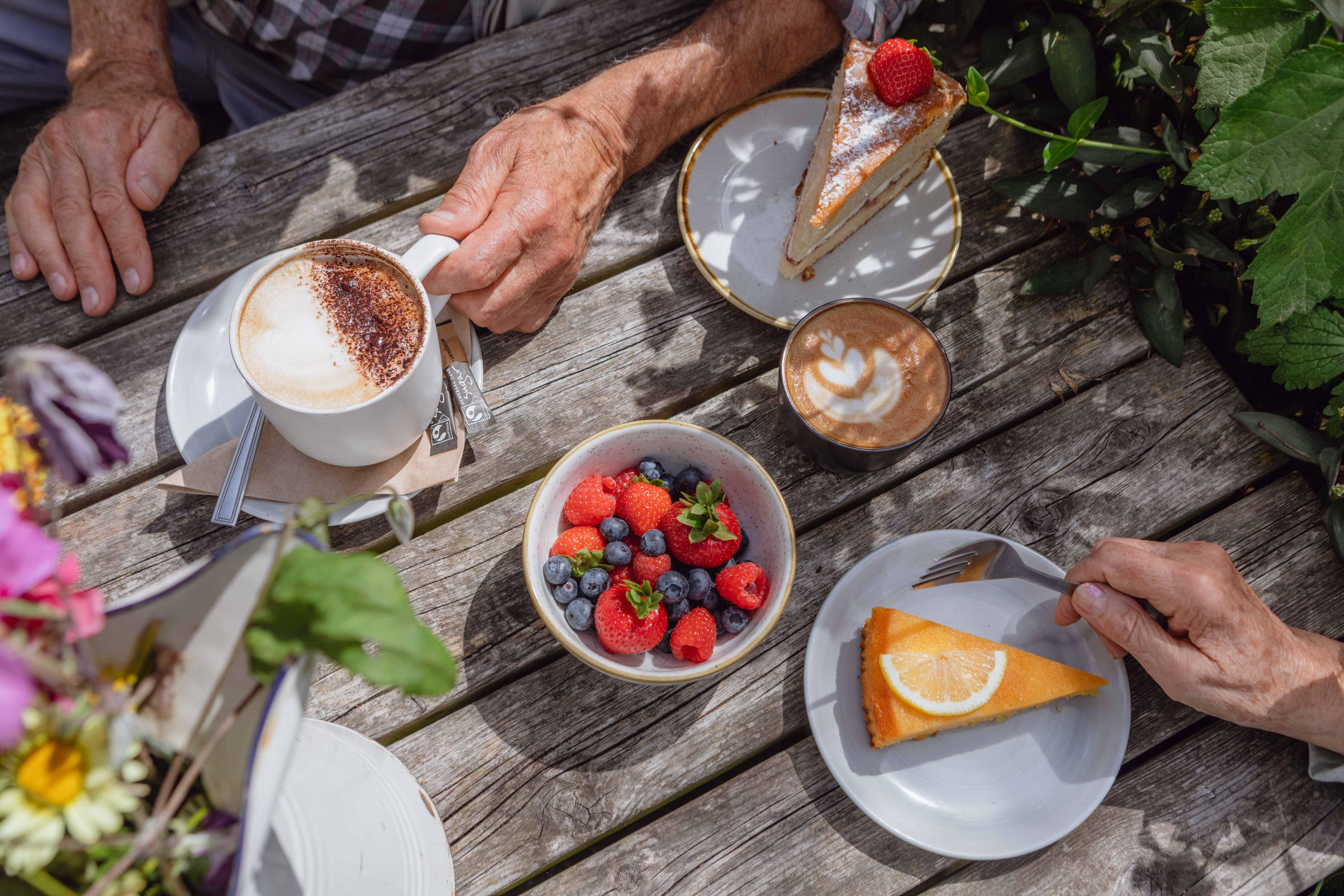 A table with cakes, fruit and coffee at Great Dixter, Sussex