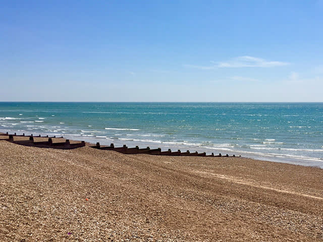 Goring Beach on a sunny day with views over the beach out to the sea