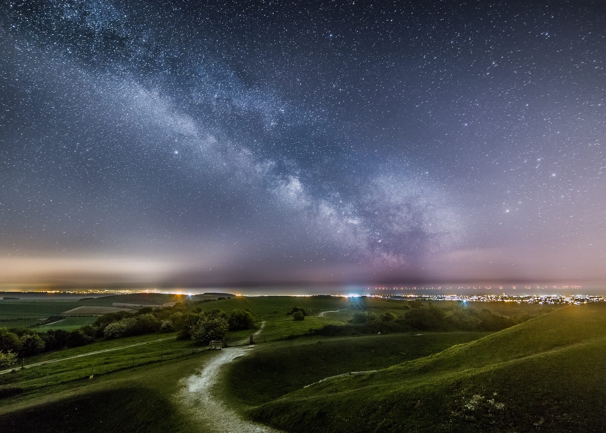 Beautiful night time landscape of the South Downs with star constellations in the night sky
