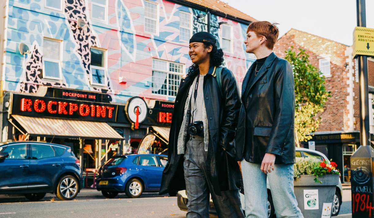 Two people walk past Rockpoint Records in New Brighton.