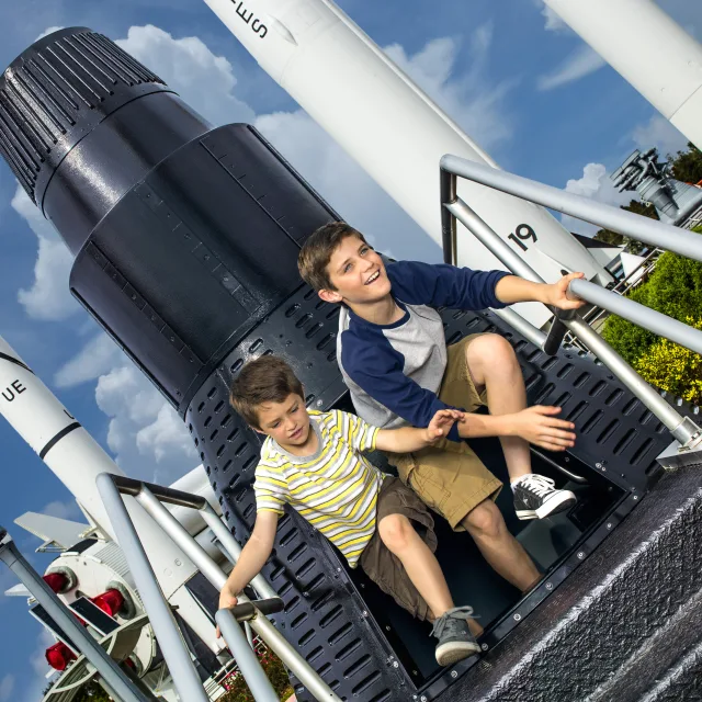 Kennedy Space Center Visitor Complex boys at rocket capsule