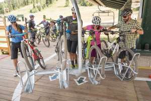 Group loading mountain bikes onto chairlift at Deer Valley Resort.