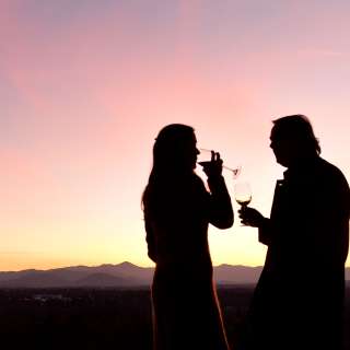 Couple drinking wine on Sunset Terrace at The Omni Grove Park Inn