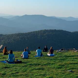People doing mountaintop yoga on Bearwallow Mountain