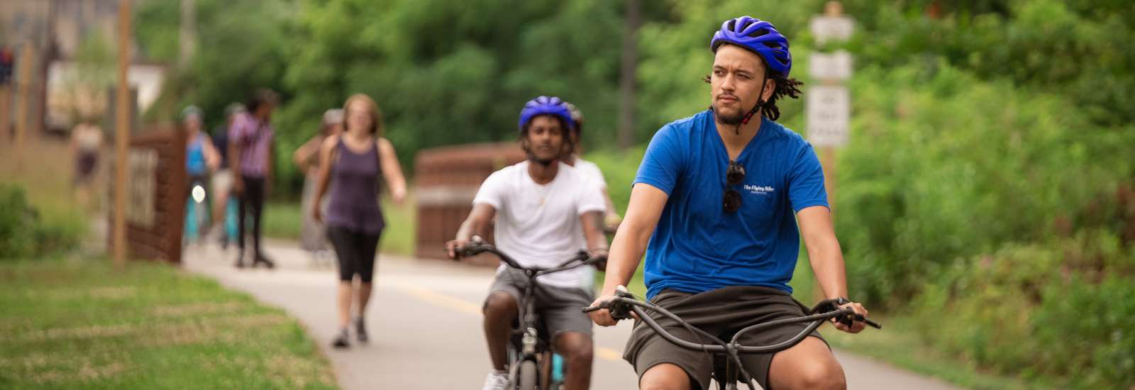 Two men riding bikes along the greenway in Asheville