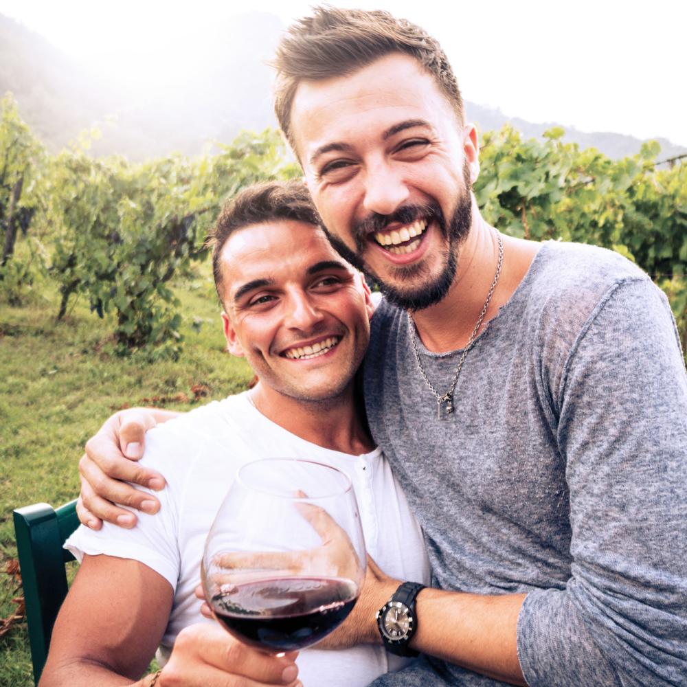 A one-line drawing romantic couple enjoying a glass of red wine in a scenic  vineyard landscape