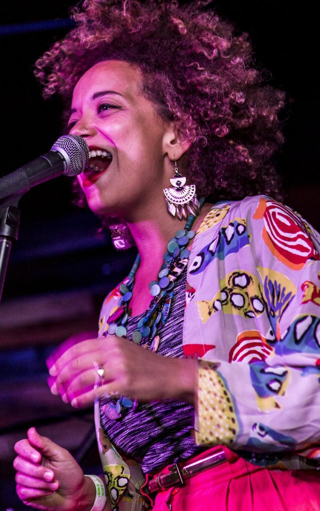KP & The Boom Boom singer on stage with a guitarist playing behind her