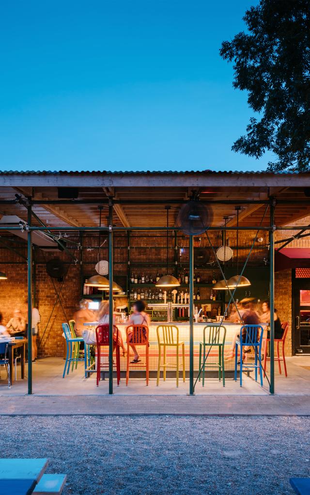 People dining at the colorful bar at Home Slice in Austin Texas