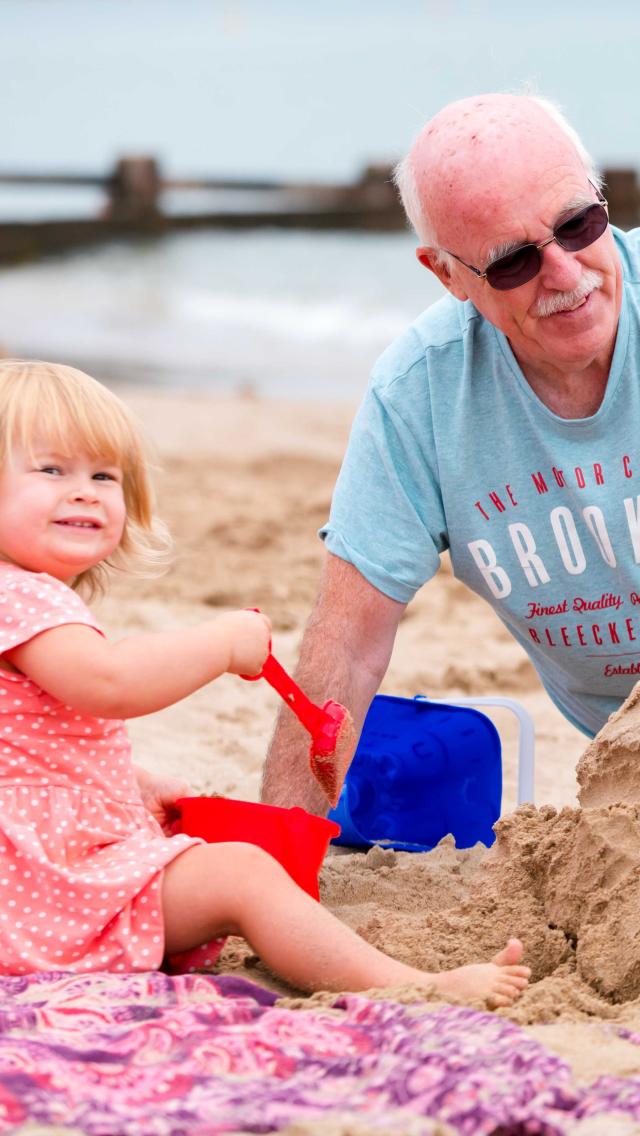 Family building sandcastles on Swanage Beach in Dorset
