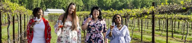 Group of women walking through vineyard