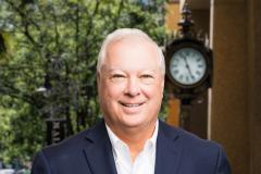 Bill Helen Headshot with city background
