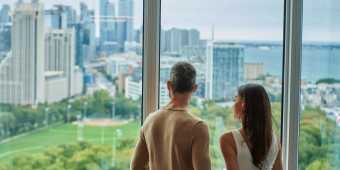 A couple looks out at the Toronto skyline from Hotel X