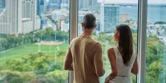 A couple looks out at the Toronto skyline from Hotel X