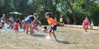 Kids playing in the sprinklers at Toronto's High Park
