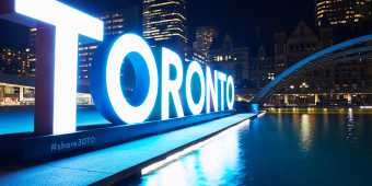 The Toronto Sign at Nathan Phillips Square lit blue
