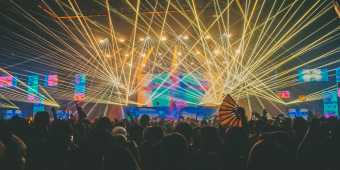 Lights and lasers over a crowd at an electronic music concert
