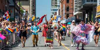People from Toronto's Indigenous community take part in the Toronto Pride festival parade.