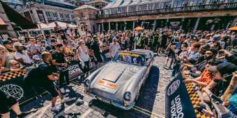 Maximillion Cooper and Eve leave London in silver car surrounded by crowds