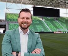 Drew Hays of Visit Austin inside Q2 Stadium