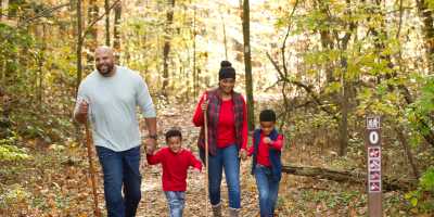 Family hiking Deam Lake Knobstone Trail in the fall