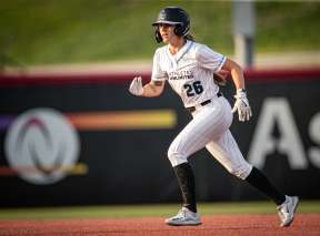 Sydney McKinney runs to a base during a softball game