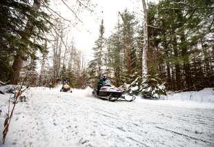 35 Snowmobile Rider on Snowmobile Trail in Eagle River