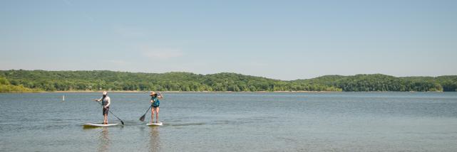 Two people paddleboarding on Monroe Lake