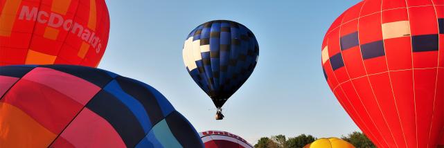 Several hot air balloons in mid-launch at the Kiwanis Indiana Balloon Festival