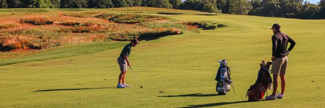 Two men playing golf at the Pfau Course