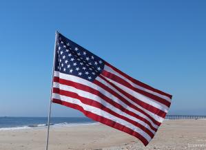 American flag waving on the beach