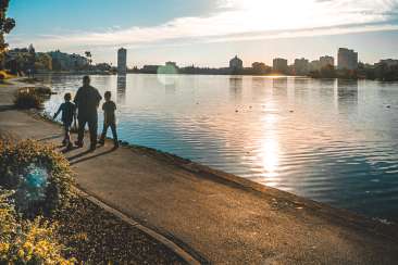 Family walking at Lake Merritt during the day