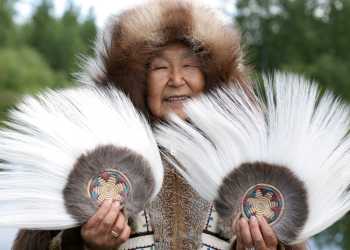 Alaska Native people; woman with Yupik dance fans