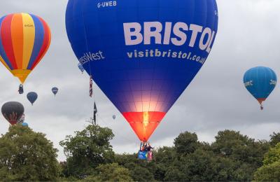 A group of balloons lifting off in a mass ascent at Bristol International Balloon Fiesta 2025