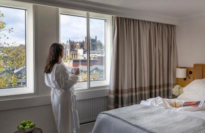 a view of a woman looking out the window of Bristol Cathedral and The Harbourside at The Bristol Hotel
