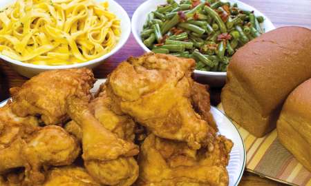 Amish style dinner of fried chicken, noodles, green beans, and bread