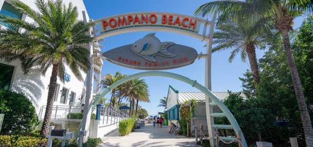 The entrance to the Pompano Beach Pier, on a bright sunny day, in Pompano Beach Florida