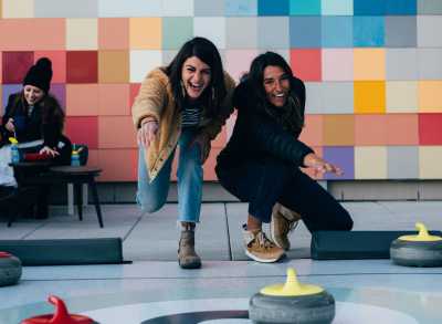 Women playing curling at Halcyon Hotel rooftop