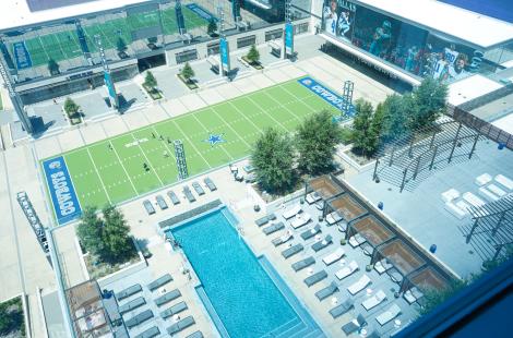 aerial shot looking down at Omni Frisco Hotel pool and Tostitos Championship Plaza